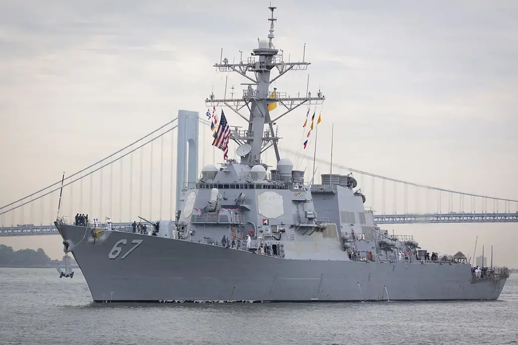 Guided-missile destroyer USS Cole (DDG 067) approaching Sullivan's Piers with the Verrazzano-Narrows Bridge in the background. The ship is part of Fleet Week NY. Image by Glynnis Jones / Shutterstock.com. United States, 2014.