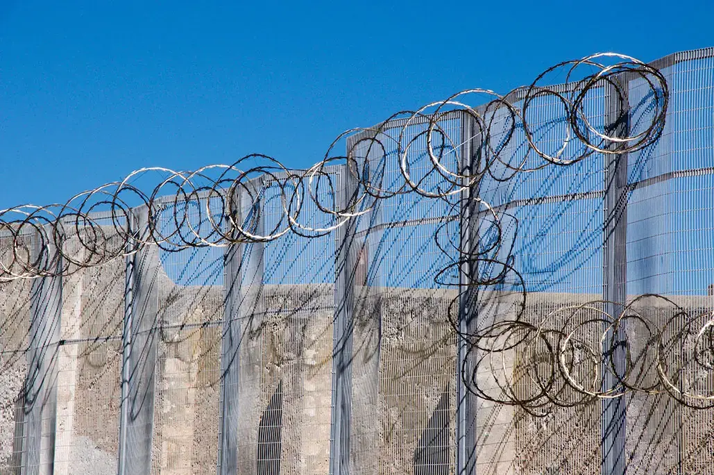 Razor wire fence at the Fremantle Prison in Fremantle, Western Australia. Image by Shutterstock. Australia, 2016.