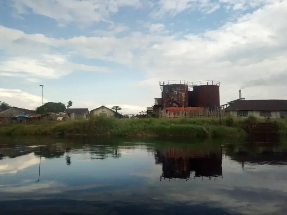A view from the river of a PHC Boteka factory. Image courtesy of EnviroNews. Democratic Republic of Congo. A view from the river of a PHC Boteka factory. Image courtesy of EnviroNews. Democratic Republic of Congo, date unknown.