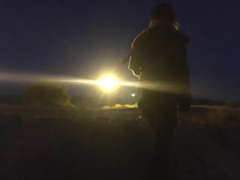 In the dry riverbed that separates Mexico from the United States, the promise of a better life is only a few hundred feet away. This woman is a 23-year-old Mexican from Ciudad Juarez who asked to remain anonymous. Everything beyond the flood light is El Paso, Texas, on the other side of the fence. She is trying to cross illegally. “There’s work here but the wages are very low,” she told us this past weekend. “You can barely survive here… Life there is better than here.” Image by Nicholas Schifrin. Mexico, 2