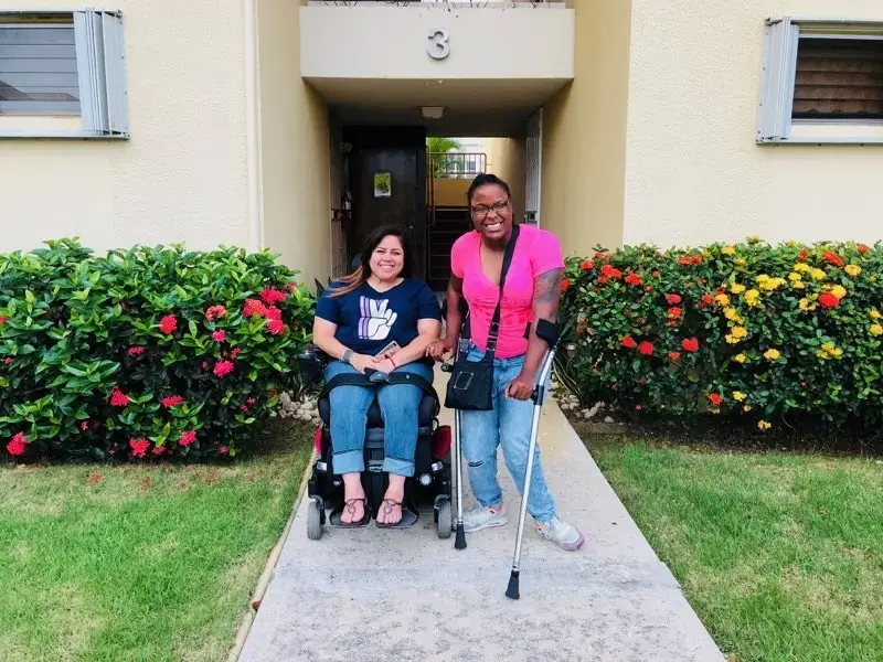 Keishla Rolón (left) and Alexis Smith in front of Keishla's home in Puerto Rico. Image by Kyja Reeves. United States, 2018.