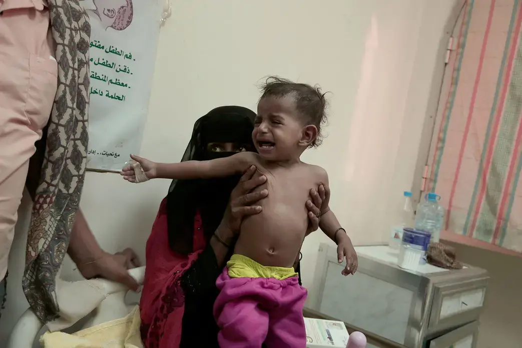 Umm Molham and her her 13-month-old son. Image by Nariman El-Mofty. Yemen, 2018.
