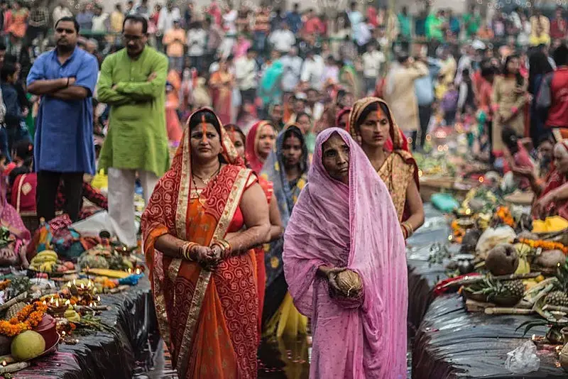 People pray during Chhath, an ancient Hindu festival that gives gratitude to the sun god for sustaining life on Earth. Image by Yogendra Singh. India, 2018.