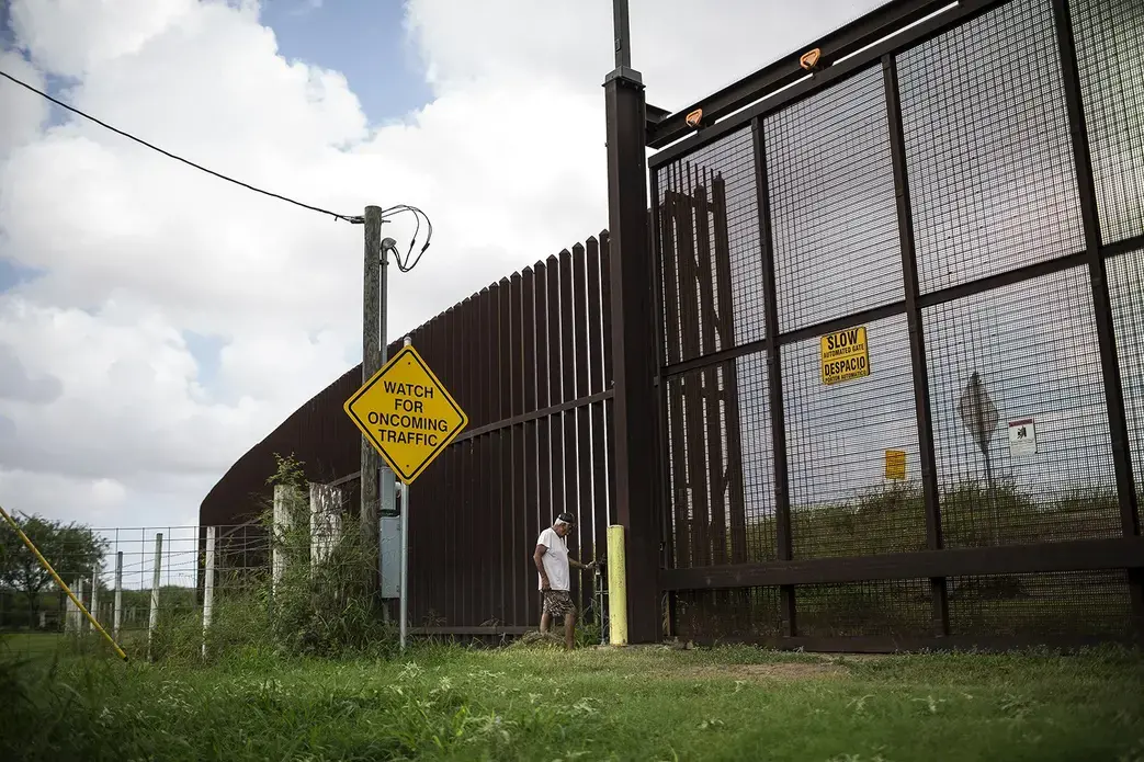 Juan Cavazos of Brownsville, Texas at the electronic gate in the border fence that runs through his property. Image by Martin do Nascimento for The Texas Tribune. United States, 2017.