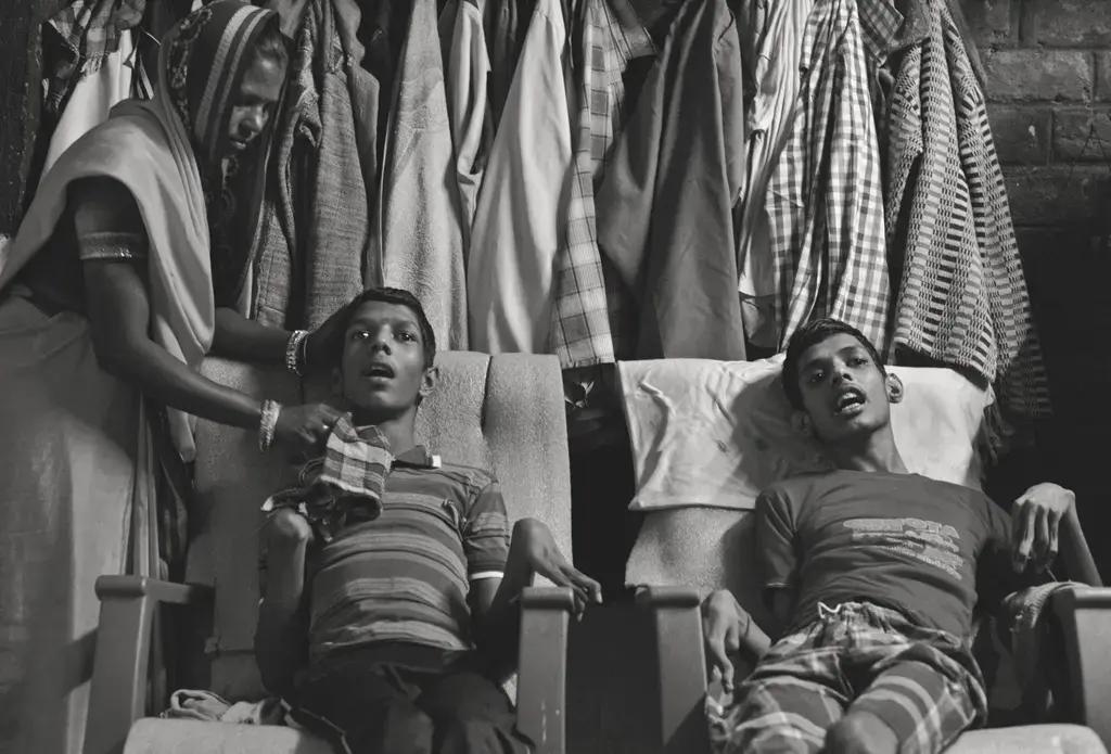 Living victims: Vikas Yadav, 19, and Aman Yadav, 17, brothers, have muscular dystrophy and are being cared for by their mother at their home. Affected by toxic waste which seeped into the groundwater, they will live short, painful lives. Image by Rohit Jain. India, 2018.