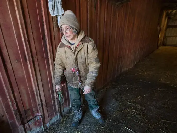 Exhausted from eight hours of chores by early afternoon, Sue Spaulding rests a moment. Image by Mark Hoffman/The Milwaukee Journal Sentinel. USA, 2019. 