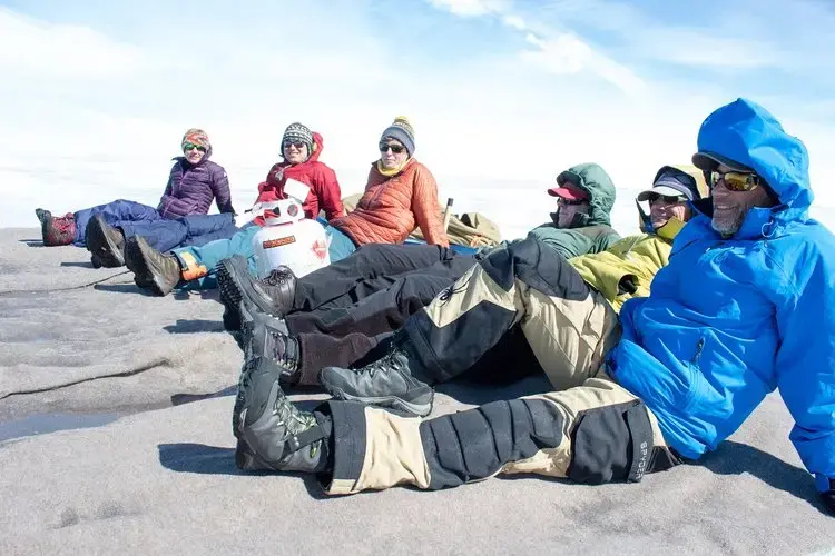 After five days of intense work, the team from the universities of Montana and Wyoming team packed up all the tents, food and gear, and waited for the helicopter to come pick them up. Image by Amy Martin. Greenland, 2018. 