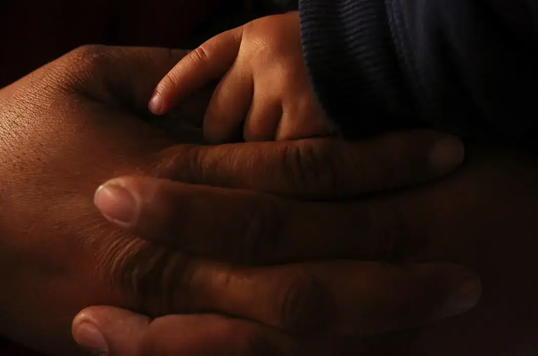Juan Carlos and Aracely stayed with their children at a shelter in Tijuana, Mexico. Earlier this spring, Aracely wanted to finish their application for asylum in the United States. Juan Carlos worried the application could be denied and they could be sent back to El Salvador, where gangs threatened their lives. They eventually decided the risk was too high to continue with their asylum appointment in California. The couple recently found a home and jobs and are trying to provide for their family in Tijuana. Image by Erika Schultz. Mexico, 2019.