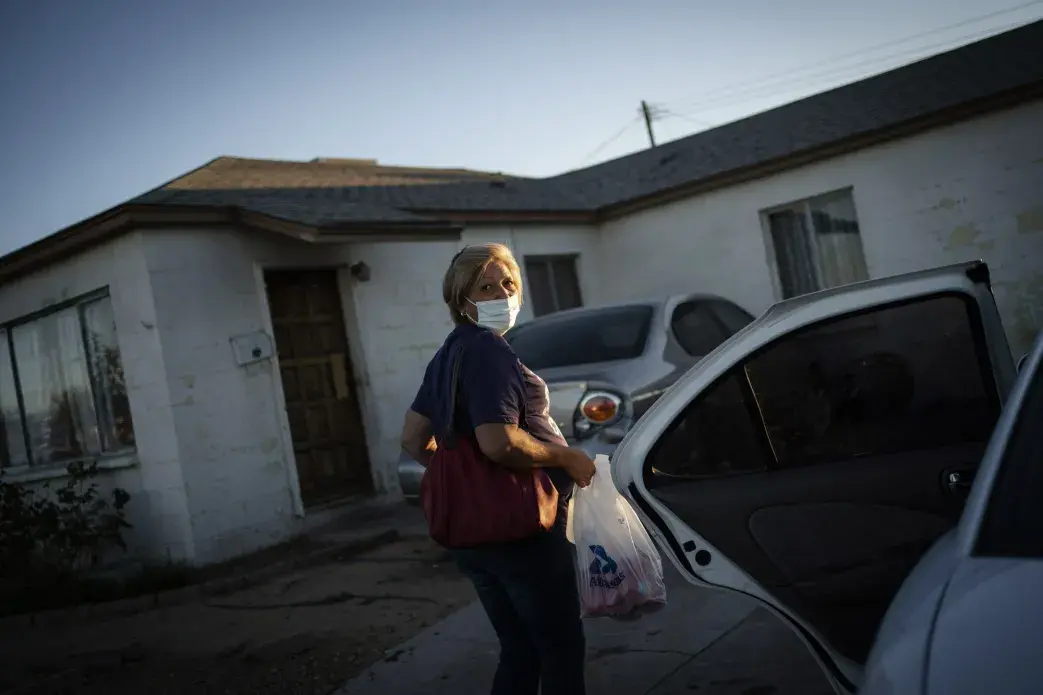 Norma Flores carries her groceries into her home in Henderson, Nev., Tuesday, Nov. 10, 2020.&nbsp;Image by Wong Maye-E / AP Photo. United States, 2020.