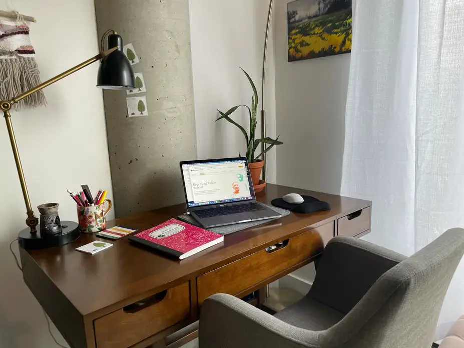 Aerial view of a desk with a laptop open.
