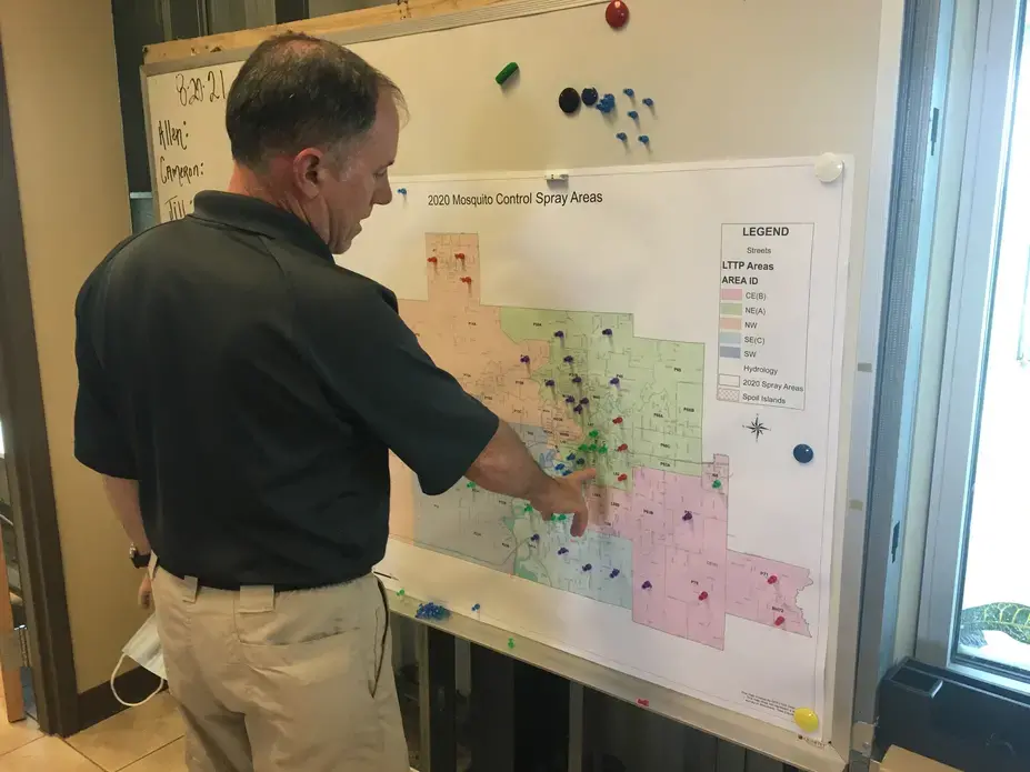 Scott Harrington, Calcasieu Parish Mosquito Control manager, in front of map