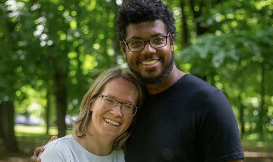 A man and woman pose happily, together