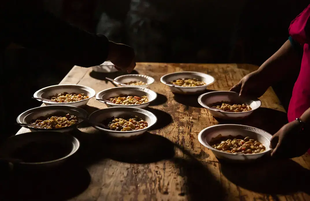 Cooks prepare lunch in a shelter for migrants in Tijuana. Image by Erika Schultz. Mexico, 2019.