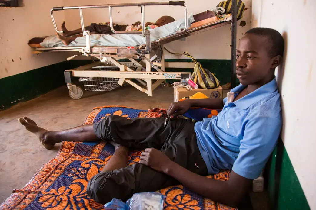 Oumar Abdouly, 24, recuperates in Chinko’s clinic after falling ill with parasites. Image by Jack Losh. Central African Republic, 2018.