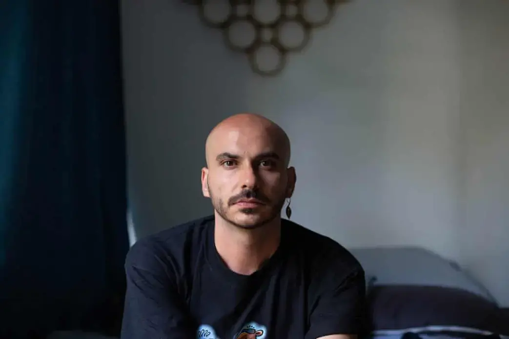 Originally from Raqqa, Syria, Hamoudi was forcibly outed as gay at the age of 13, when he was caught having sex with a male friend. He actively protested against the Syrian regime and Islamic State and faced physical and psychological torture. Since moving to Berlin, Hamoudi has worked in the cultural sector and most recently with an organisation helping to rebuild civil society in Raqqa. Image by Bradley Secker. Germany, 2020.
