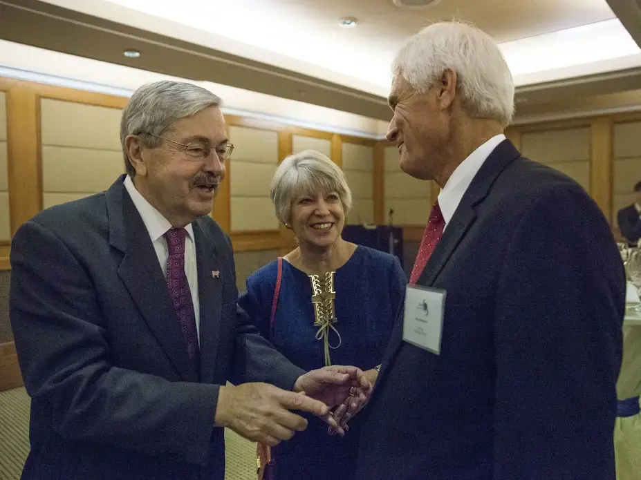 Terry Branstad, U.S. ambassador to China, and his wife, Chris Branstad say hello to Rick Kimberley, a corn and soy bean farmer from Iowa, during an Iowa Sister States reception on Wednesday, Sept. 20, 2017, in Beijing, China. A groundbreaking will be held this weekend for a replica of Kimberley's family farm being built in China. Image by Kelsey Kremer. China, 2017.