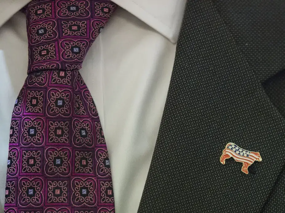 Terry Branstad, U.S. ambassador to China, wears an American beef lapel pin during an Iowa Sister States reception on Wednesday, Sept. 20, 2017, in Beijing, China. He spoke on Wednesday about American beef being allowed back in China, for the first time in 14 years, the at the start of his tenure as ambassador. Image by Kelsey Kremer. China, 2017.