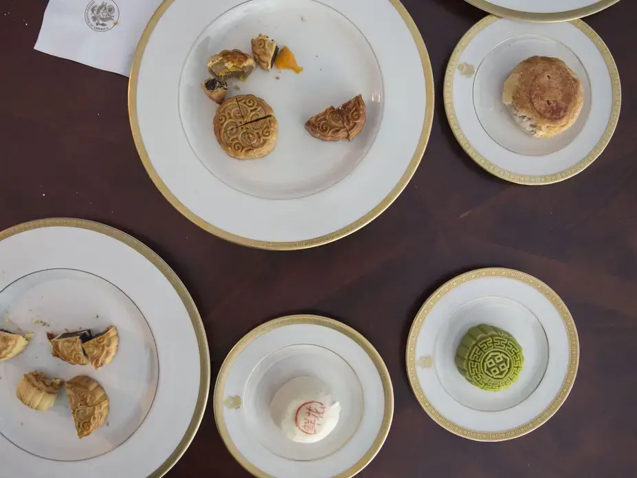 Mooncake pieces and crumbs are left behind after the Branstad family tried the sweets for a Mid-Autumn Festival video filmed by members of the U.S. Embassy staff on Sunday, Sept. 24, 2017, at the ambassador's residence in Beijing. Mooncakes are traditionally eaten to celebrate the holiday, which fell on Oct. 4 this year. Image by Kelsey Kremer. China, 2017.