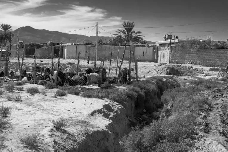 A long crack in the earth in Chah Deraz village, near Lake Bakhtegan. The drought has led to cracked earth and sinkholes in the neighboring farms and land. Image by Ako Salemi. Iran, 2016.