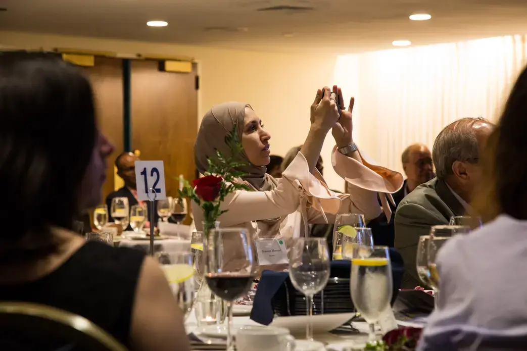 Sawsan Morrar, 2017 UC Berkeley Graduate School of Journalism fellow, photographs during the evening remarks. Image by Lorraine Ustaris.&nbsp;Washington, D.C., 2018.&nbsp;