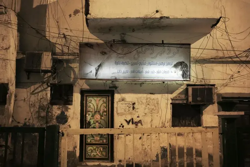 This Feb. 13, 2018, photo shows damage and bullet holes from the country’s civil war outside a women’s hair salon in Aden, Yemen. The mood is eerie on the mostly empty streets of Aden, Yemen’s southern port city and erstwhile seat of government that has suffered three years of civil war. Image by Nariman El-Mofty. Yemen, 2018. </p>
<p>