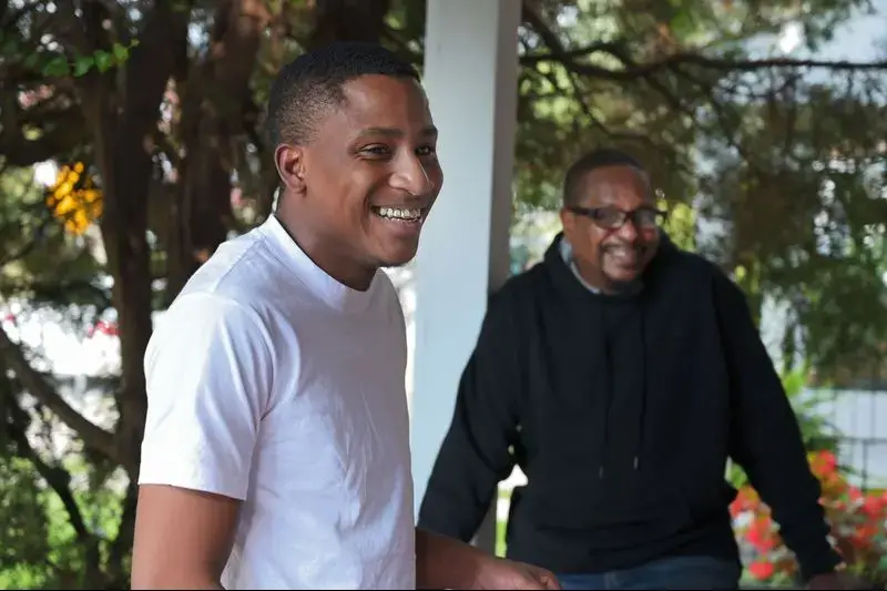 Cecil 'C.J.' Burton III, left, said his father 'never stopped trying' to provide for him and his siblings, despite the child support debt that piled up over decades. Now 54, Cecil Burton is still paying the debt, much of which is owed the government for welfare C.J. and his siblings received when growing up. Image by Karl Merton Ferron / Baltimore Sun. United States, 2019. 