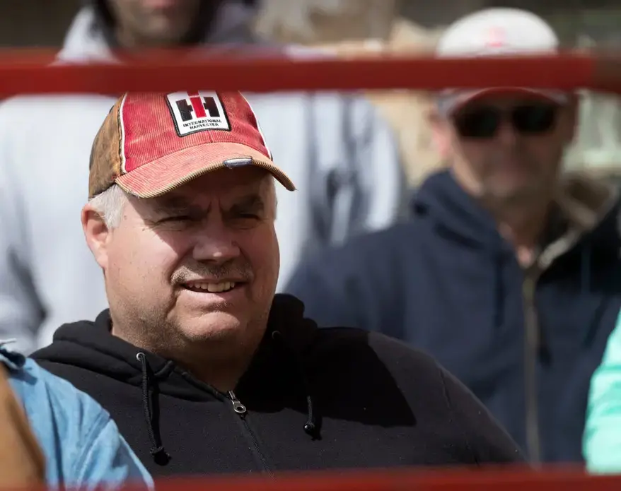 Dale Ryan watches people bid on livestock. Image by Mark Hoffman. United States, 2019.