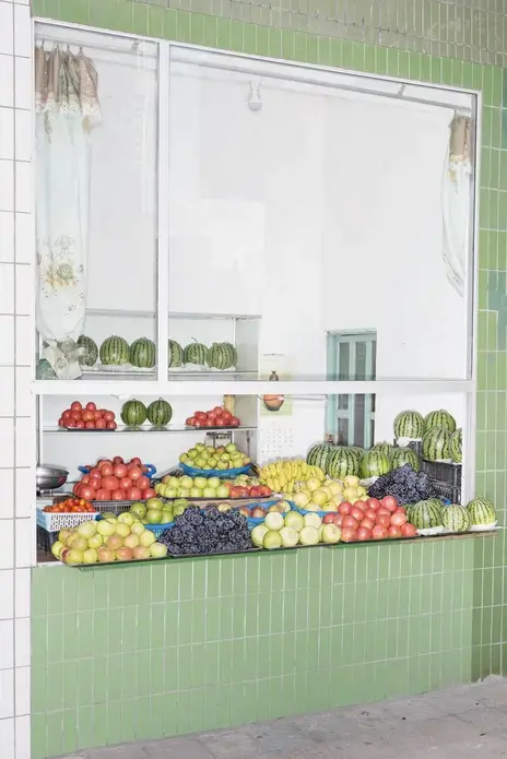 A fruit stall outside a station of the Pyongyang Metro. Image by Max Pinckers/The New Yorker. North Korea, 2017.
