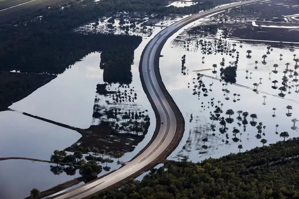 During times of extreme rain, such as Hurricane Harvey, Houston’s Barker Reservoir (or, as part of it is called on the west side of the city, George Bush Park) impounds water from the larger river called Buffalo Bayou, in order to prevent flooding downstream. Image by Alex MacLean. United States, 2017.