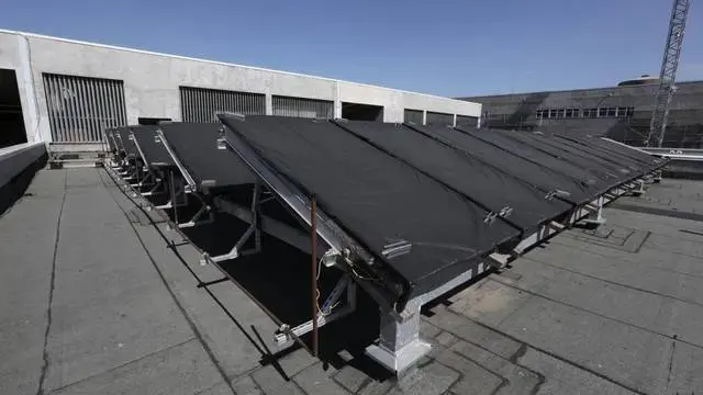 Solar panels on the roof of the new General Hospital have been damaged by bullets from protests. The sprawling new hospital campus was one of the first projects approved for Haiti’s reconstruction following the earthquake of Jan. 12, 2010. Image by Jose A. Iglesias. Haiti, 2019.