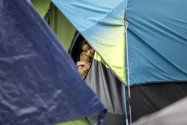 The camp near the Gateway International Bridge, which connects Matamoros and Brownsville, began forming last year. Media reports say Mexican officials plan to move the migrants to a stadium farther from the river. Image by Miguel Gutierrez Jr. Mexico, 2019.