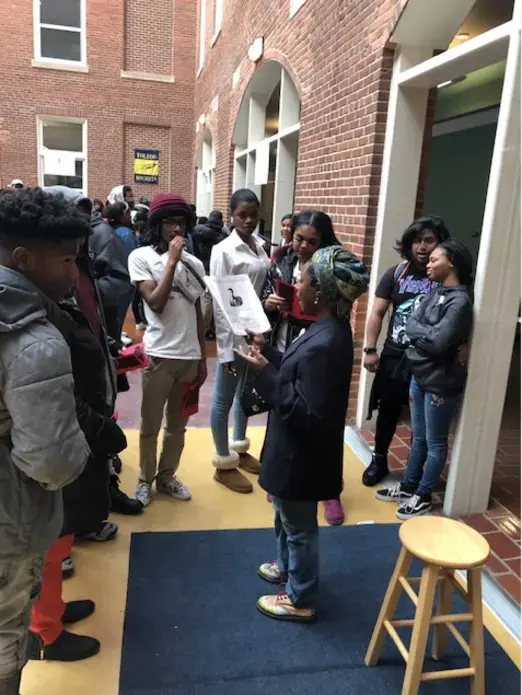Image of a student reciting poetry from The 1619 Project for students as part of an event 