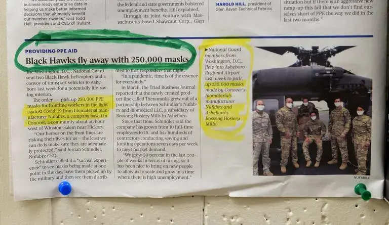 ASHEBORO, NORTH CAROLINA - A newspaper clipping features three Black Hawk helicopters that came to pick up the federal governments order of 250,000 Theramasks inside the Bossong Medical plant in Asheboro, NC on Thursday, July 16, 2020. The Bossong Medical plant in Asheboro contracted to make Nufabrx items. Image by Jeff Siner/The Charlotte Observer/North Carolina News Collaborative. United States, 2020.