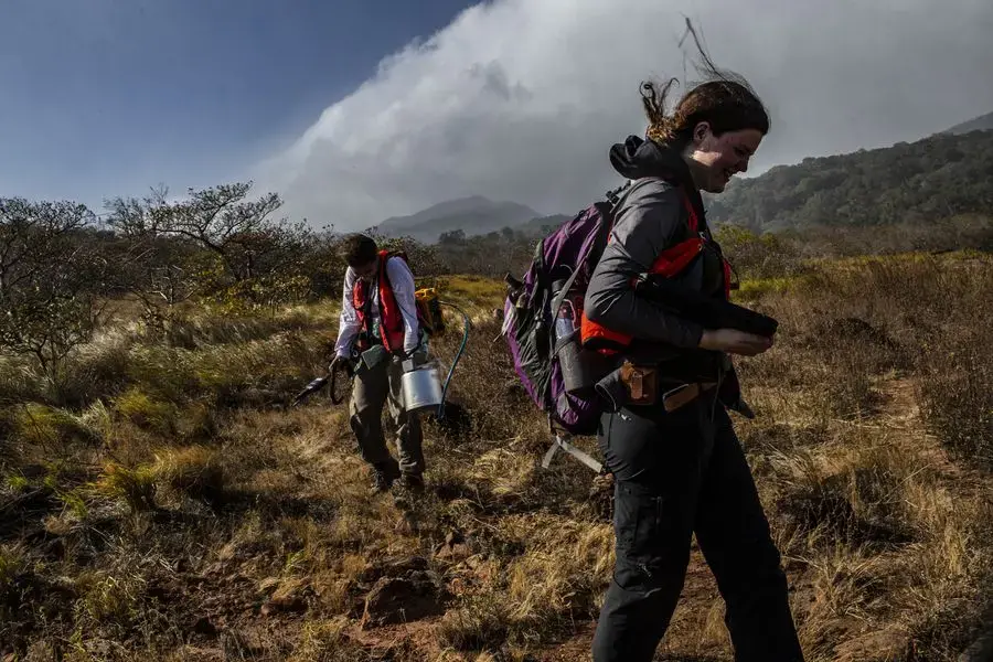 Graduate students Nel Rodriguez Sepulveda, left, and Katie Nelson walk near the volcano. They and other researchers are measuring carbon dioxide levels around Rincón de la Vieja. Image by Dado Galdieri / Hilaea Media. Costa Rica, 2020.