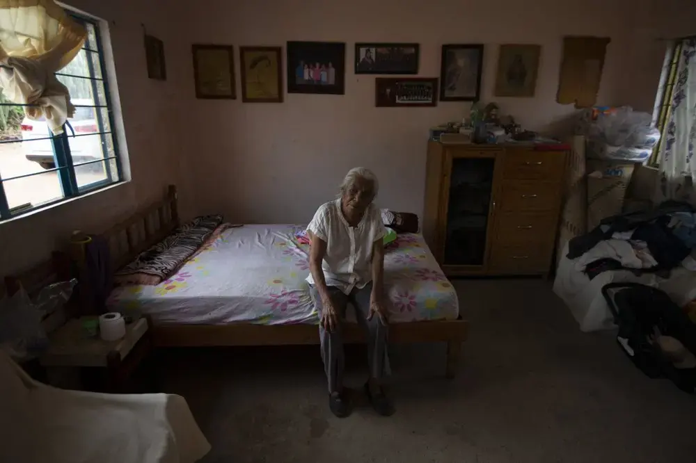 Catalina Vazquez poses for a portrait as she sits on her bed in San Jeronimo Xayacatlan, a town in Mexico from where nearly a third have emigrated to New York, Thursday, June 25, 2020. Image by Fernando Llano/AP Photo. Mexico, 2020.
