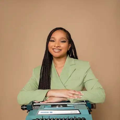 Alexis McGowan poses with an electric typewriter