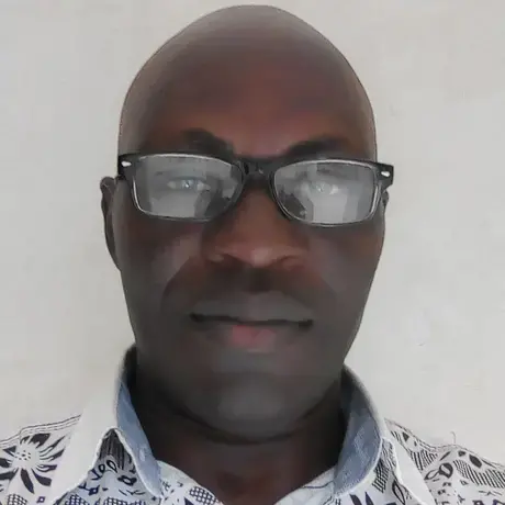 IMG_20180726_154218 (1).jpg A man wears glasses and a white shirt, he smiles at the camera.