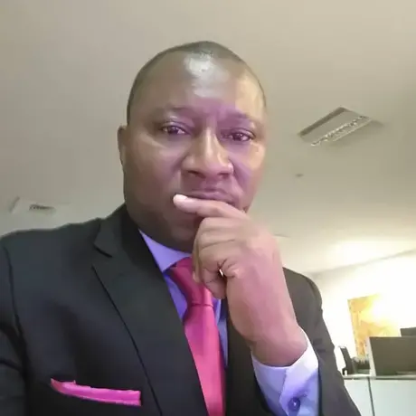 -exoh3q.jpeg A man wearing a red tie and a black jacket.