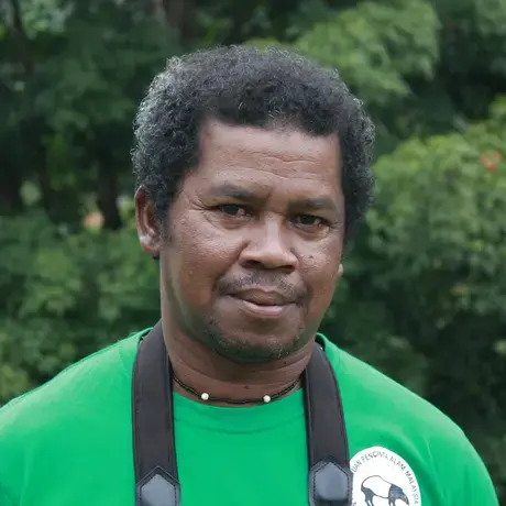 Image of a person wearing a green shirt with a tapir logo.