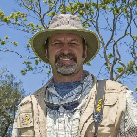 Michael Tweddle.jpg Man with a hat and a mustache looks into the camera