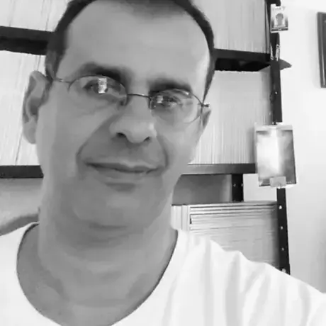 A person wears a shirt and glasses.