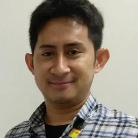 A person wears a blue jacket and black shirt.