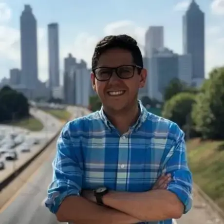 1617995638384.jpeg A man with eyeglasses and wears a blue-striped shirt.