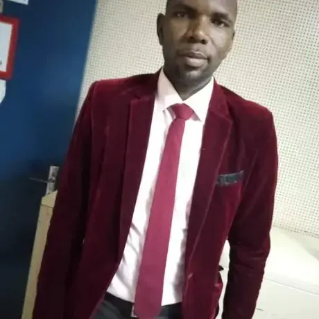 ATEH.jpg A man wearing a purple jacket and tie with a white work shirt.