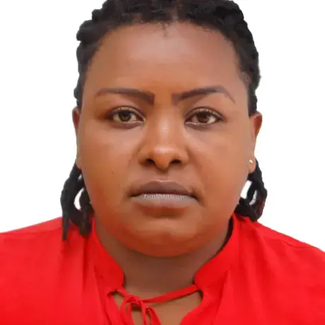 A person with braided hair and a red shirt.