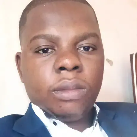 PHOTO-GRACE-MBAMBI.jpg A man with a grey suit, tie, and a white shirt.