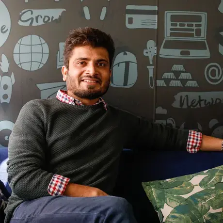 Kumar Sambhav Shrivastava posing on a sofa.