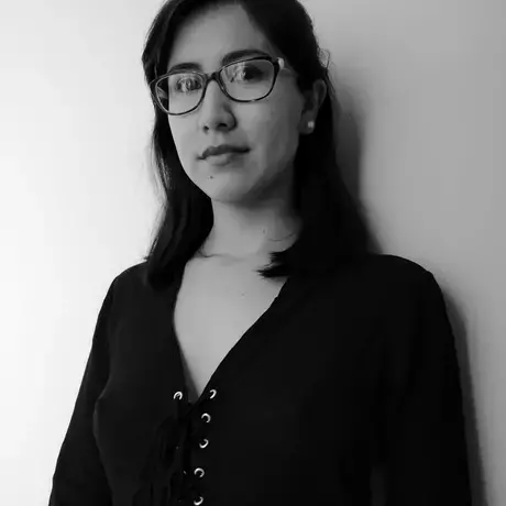 black and white headshot of a woman with long dark hair and glasses