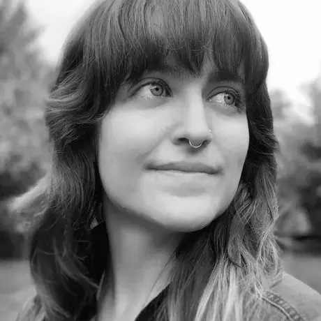 Black and white image of a woman with long hair and bangs