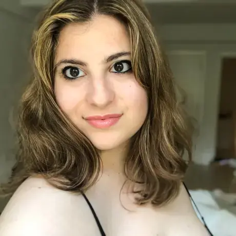 A woman with shoulder-length brown hair